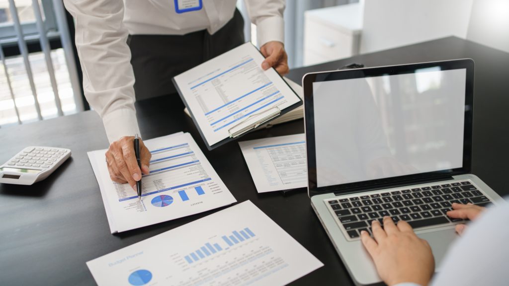 Business concept, Business man pointing on financial document to explaining information to partner.